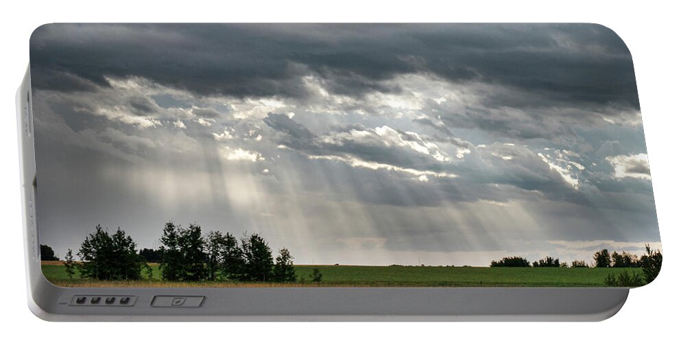 Sun Portable Battery Charger featuring the photograph Sun rays over a field by Phil And Karen Rispin