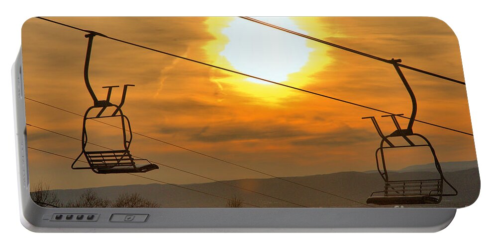 Montage Portable Battery Charger featuring the photograph Sunburst Over The Montage Chairlift by Adam Jewell