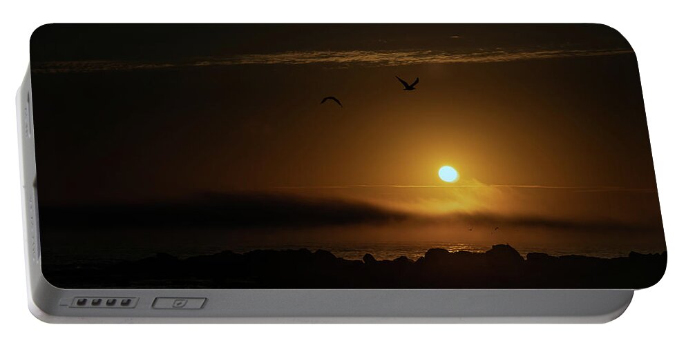 Sunset Portable Battery Charger featuring the photograph Sunset over the ocean by Micah Offman