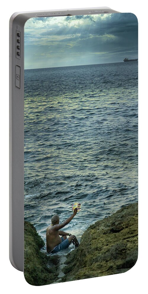 Storyteller Portable Battery Charger featuring the photograph The man who tells stories to the fishes by Micah Offman
