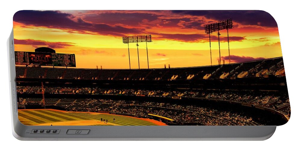 Oakland Portable Battery Charger featuring the digital art The Oakland-Alameda County Coliseum in sunset light by Nicko Prints