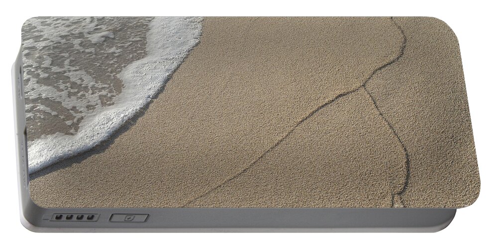 Mediterranean Coast Portable Battery Charger featuring the photograph Traces of waves on the sandy beach. Sea water meets beige sand 2 by Adriana Mueller