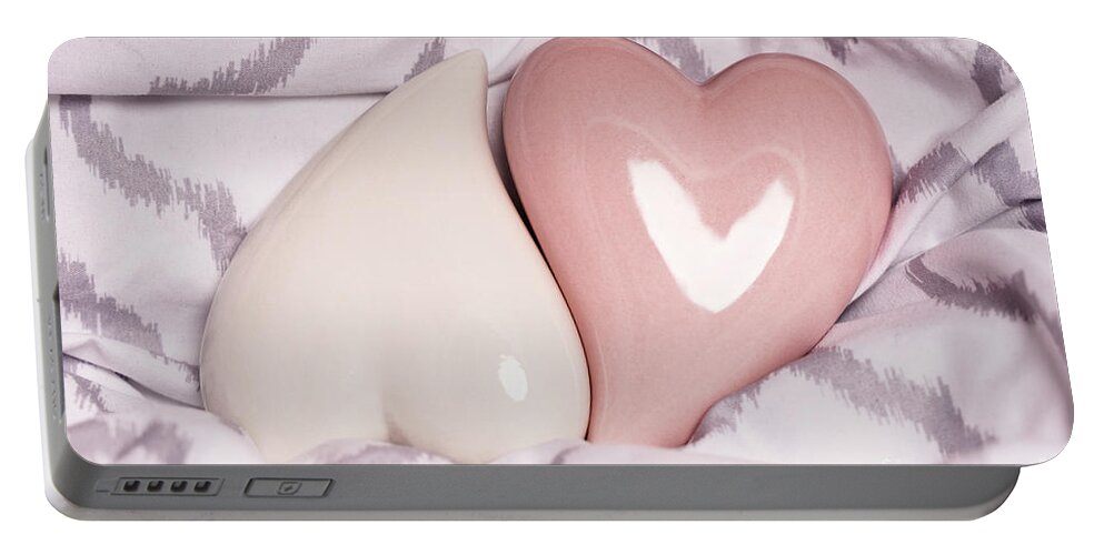 Love Portable Battery Charger featuring the photograph Two red hearts on a modern bedsheet by Mendelex Photography