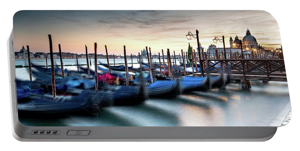 Gondola Portable Battery Charger featuring the photograph Venice Gondolas moored at the San Marco square. by Michalakis Ppalis