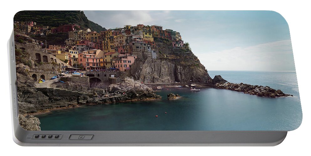 Cinque Terre Portable Battery Charger featuring the photograph Village of Manarola with colourful houses at the edge of the cliff Riomaggiore, Cinque Terre, Liguria, Italy by Michalakis Ppalis