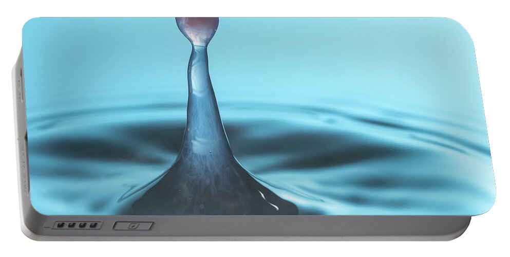 Waterdrop Portable Battery Charger featuring the photograph Water drop falling onto column of water by Steven Heap