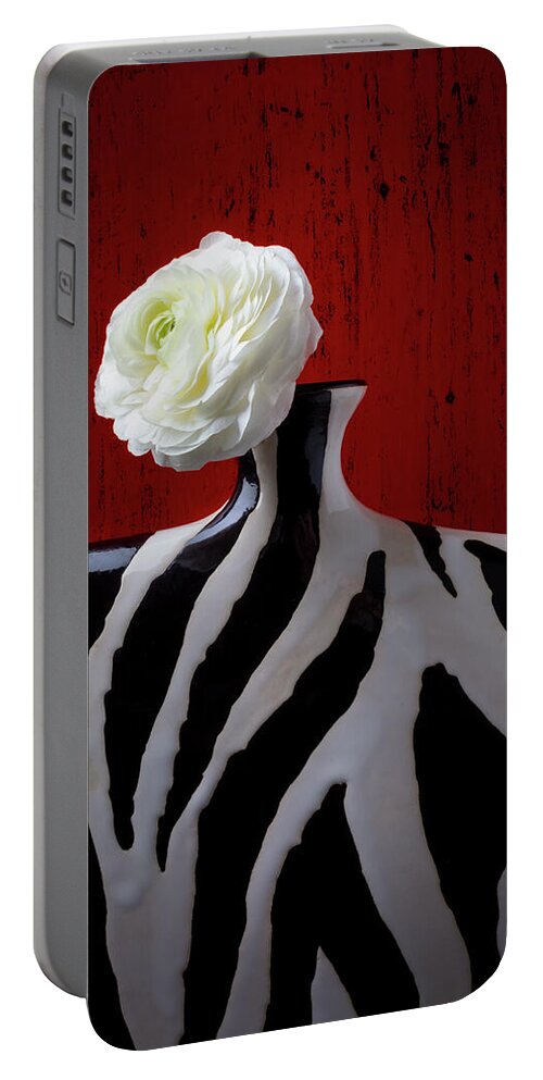  Portable Battery Charger featuring the photograph White Ranunculus In Vase Against Red wall by Garry Gay