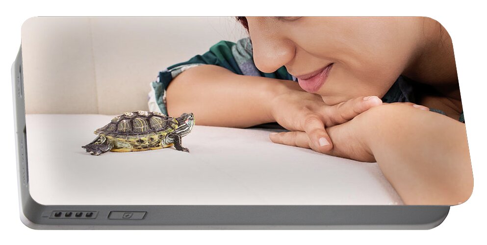 Turtle Portable Battery Charger featuring the photograph Young girl looking at a little turtle by Mendelex Photography