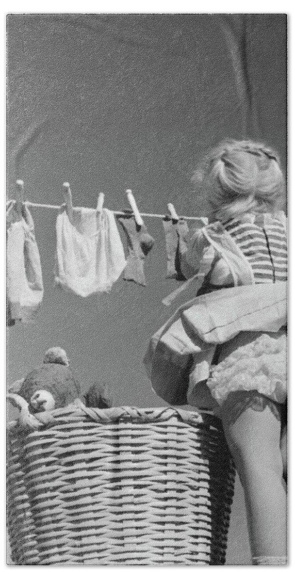 Photography Beach Towel featuring the photograph 1950s Back View Of Girl Hanging Laundry by Vintage Images