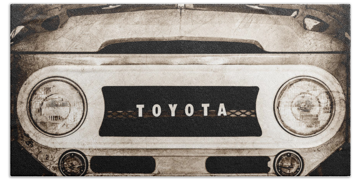 1969 Toyota Fj-40 Land Cruiser Grille Emblem Beach Towel featuring the photograph 1969 Toyota FJ-40 Land Cruiser Grille Emblem -0444s by Jill Reger