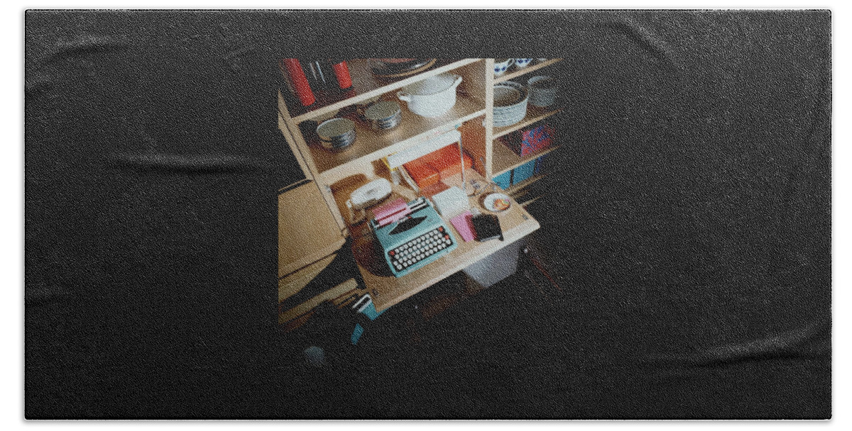 A Cupboard With A Blue Typewriter Beach Towel