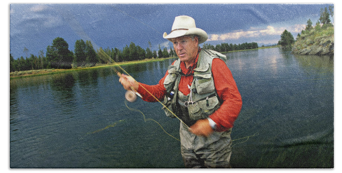 A Man In A Cowboy Hat Fly Fishing Beach Towel