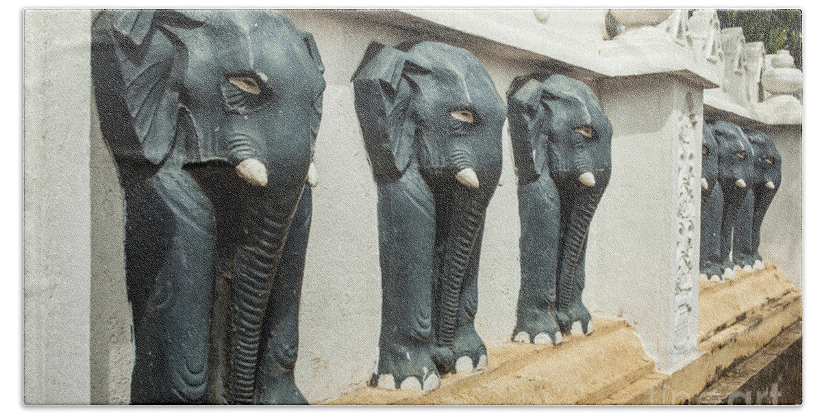 Elephants Beach Towel featuring the photograph Black elephants on temple wall by Patricia Hofmeester