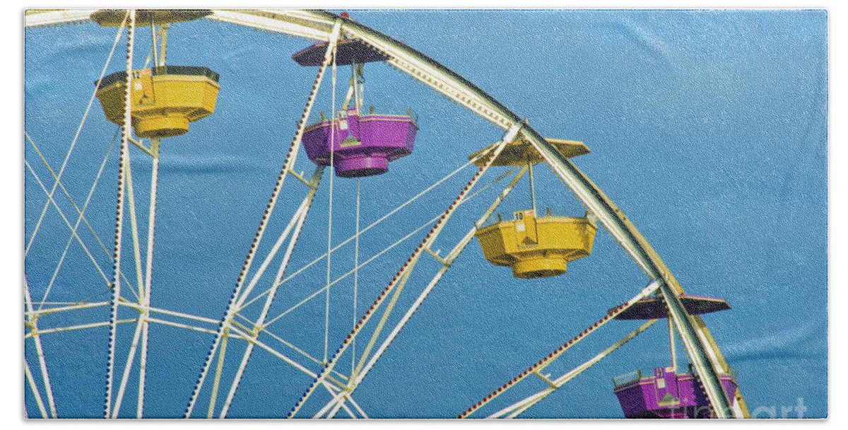 Ferris Wheel Beach Towel featuring the photograph Ferris Wheel rotating upright wheel with passenger cars by David Zanzinger