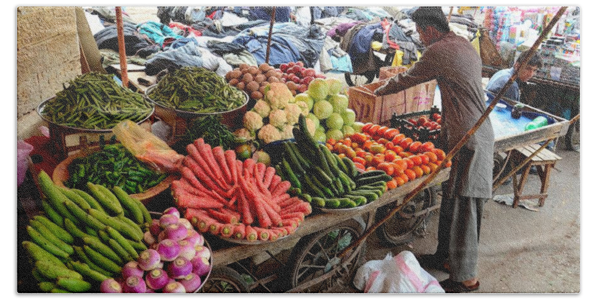 Fruits Beach Towel featuring the photograph Fruit and vegetable seller tends to his cart outside Empress Market Karachi Pakistan by Imran Ahmed