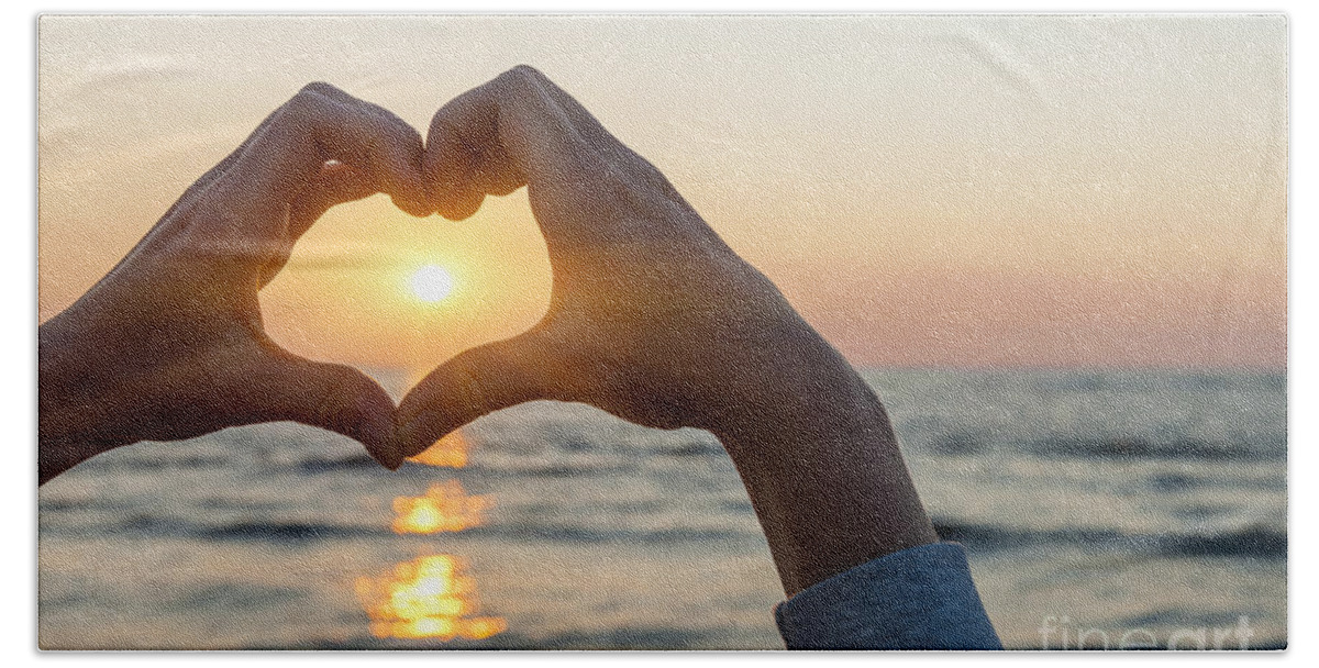 Heart Beach Towel featuring the photograph Heart shaped hands framing ocean sunset by Elena Elisseeva