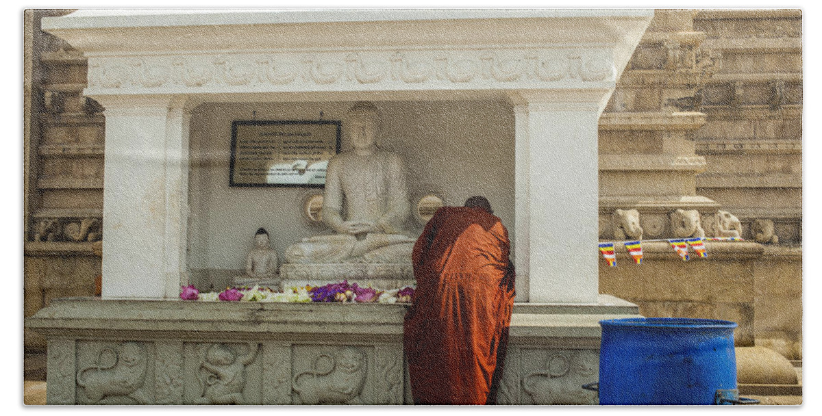 Robe Beach Towel featuring the photograph Monk praying at Ruwanwelisaya stupa in Sri Lanka by Patricia Hofmeester