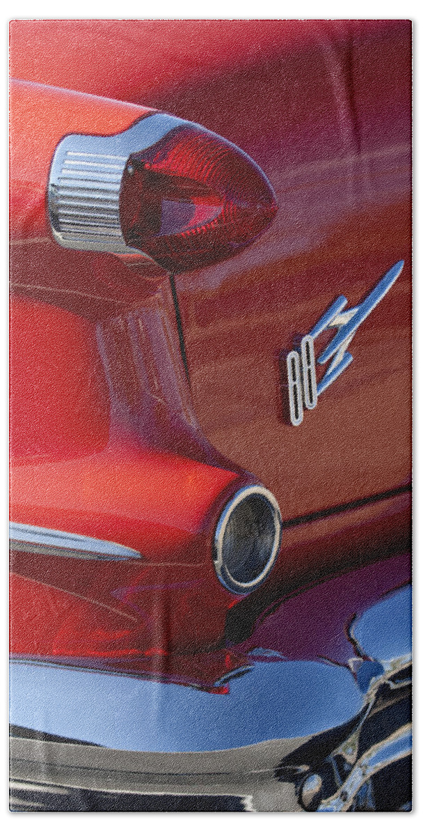 1956 Oldsmobile 88 Beach Towel featuring the photograph 1956 Oldsmobile 88 Taillight Emblem by Jill Reger