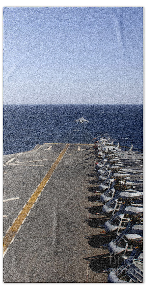 Ch-46 Sea Knight Beach Towel featuring the photograph An Av-8b Takes Off From The Flight Deck by Stocktrek Images