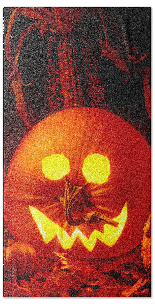 Pumpkin Beach Towel featuring the photograph Carved pumpkin with fall leaves by Garry Gay