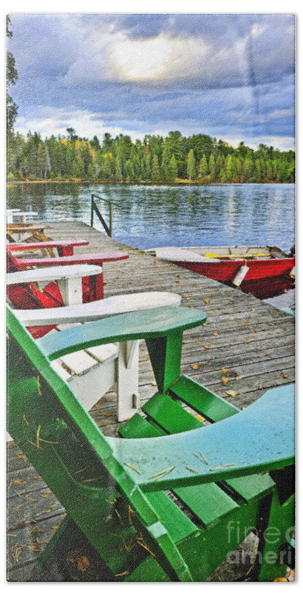 Adirondack Chairs Beach Towel featuring the photograph Deck chairs on dock at lake by Elena Elisseeva