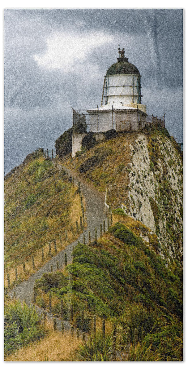 Beach Beach Sheet featuring the photograph Nugget Point Light House and dark clouds in the sky by U Schade