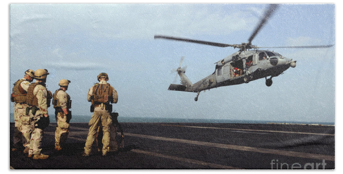 Aircraft Carrier Beach Towel featuring the photograph Sailors Prepare To Board An Mh-60s Sea by Stocktrek Images
