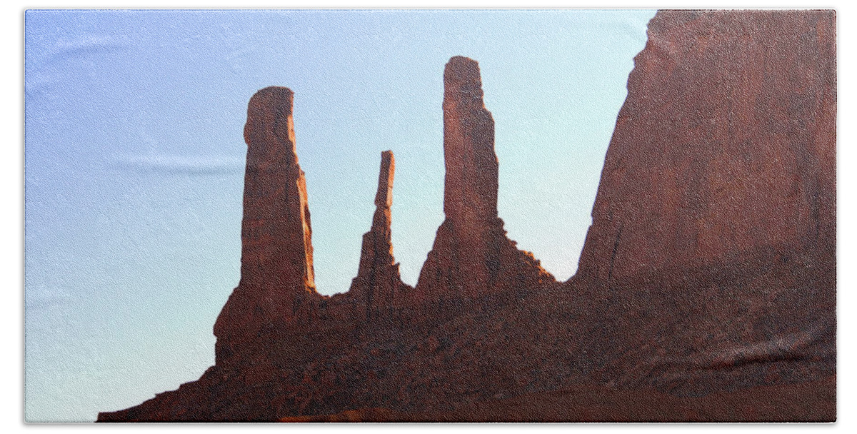 Desert Scene Beach Towel featuring the photograph Three Sisters - Monument Valley by Mike McGlothlen