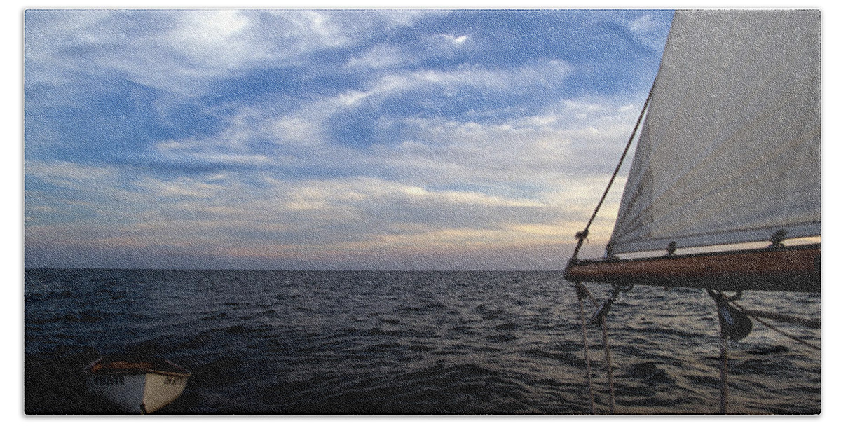 Water Beach Towel featuring the photograph A Connie Dingy follows a Classic Sailboat by John Harmon
