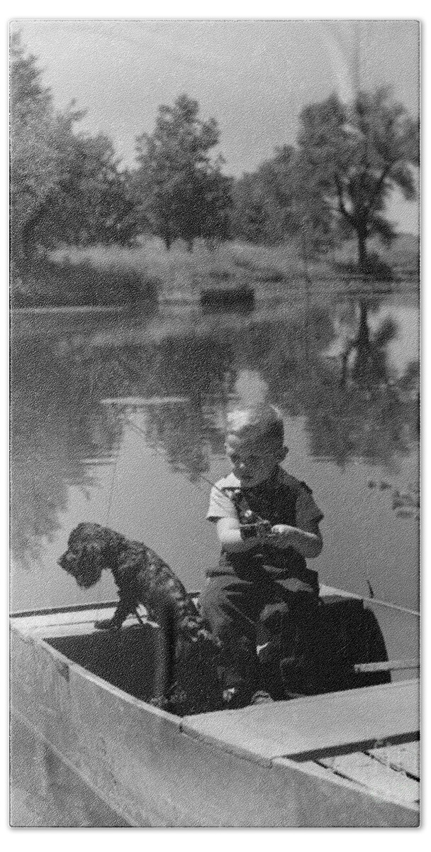 1940s Beach Towel featuring the photograph Boy With Dog In Fishing Boat by CS Bauer and ClassicStock