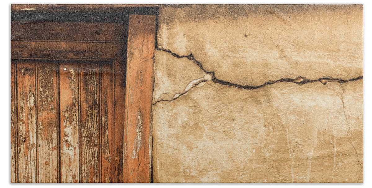 Foix Beach Sheet featuring the photograph Cracked lime stone wall and detail of an old wooden door by Semmick Photo