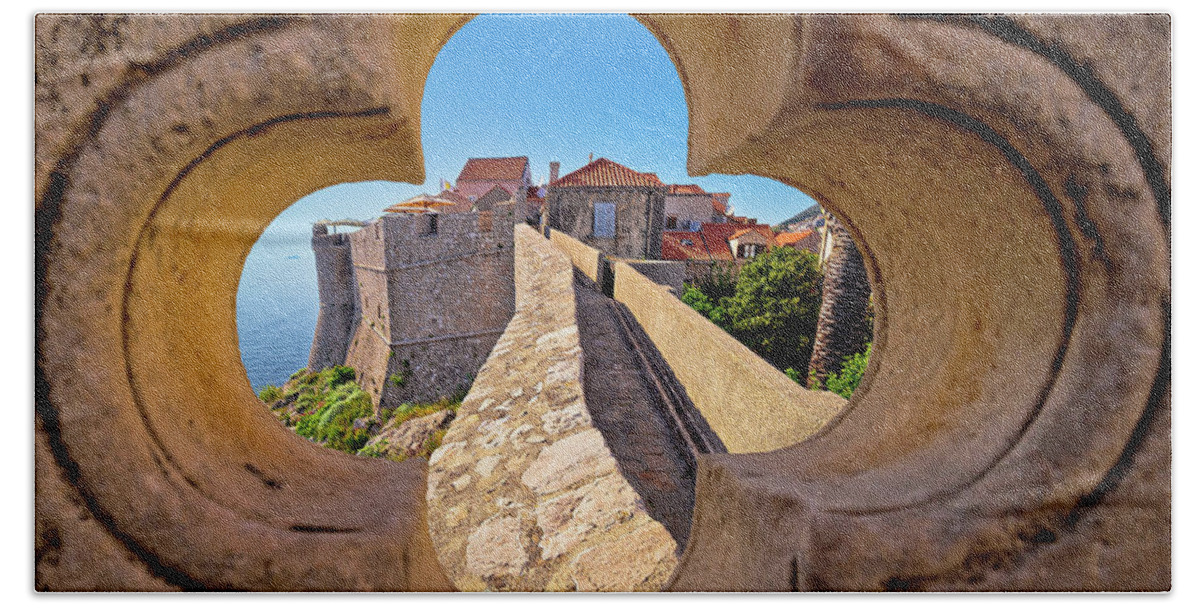 Dubrovnik Beach Towel featuring the photograph Dubrovnik city walls view through stone carved detail by Brch Photography