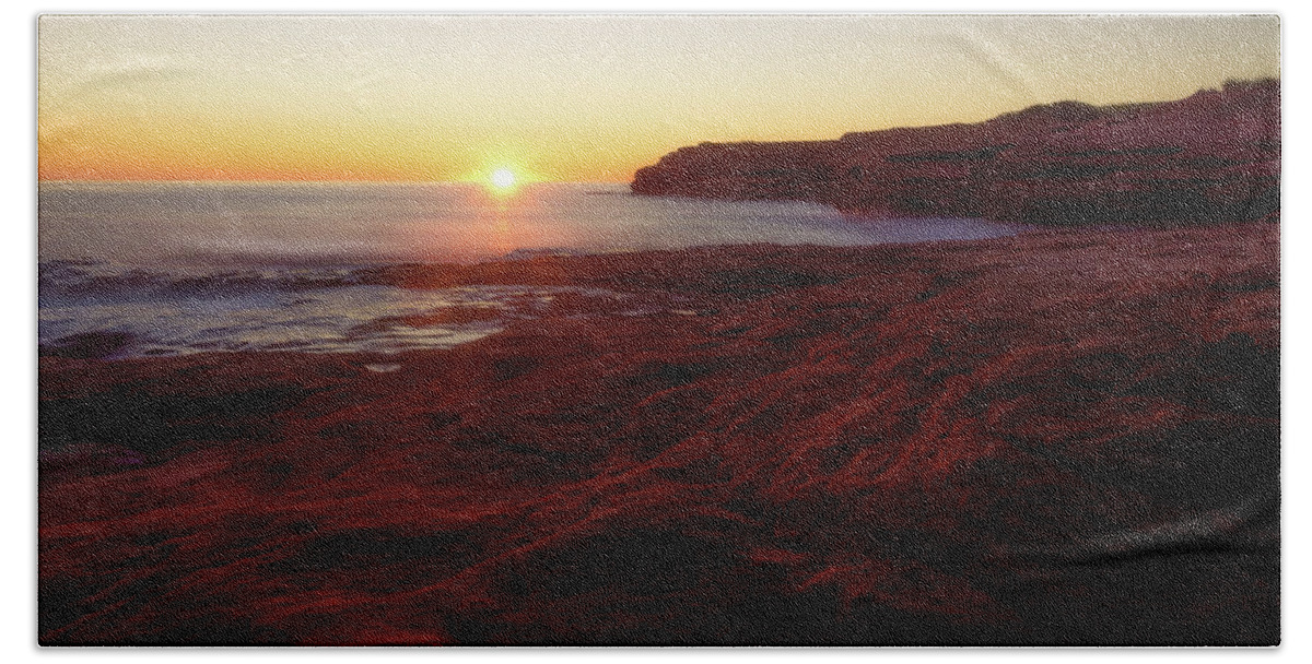 Bluffs By The Ocean Beach Towel featuring the photograph First light on Red Sandstone beach by Chris Bordeleau