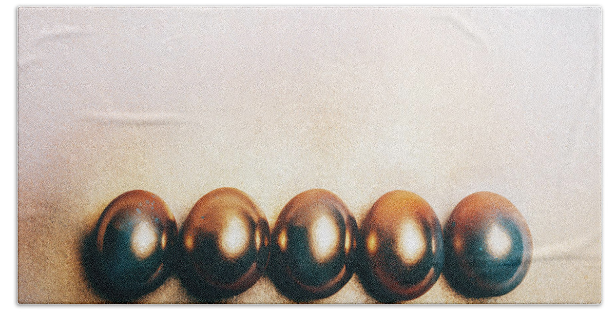 Egg Beach Towel featuring the photograph Five golden eggs laying on the floor. by Michal Bednarek