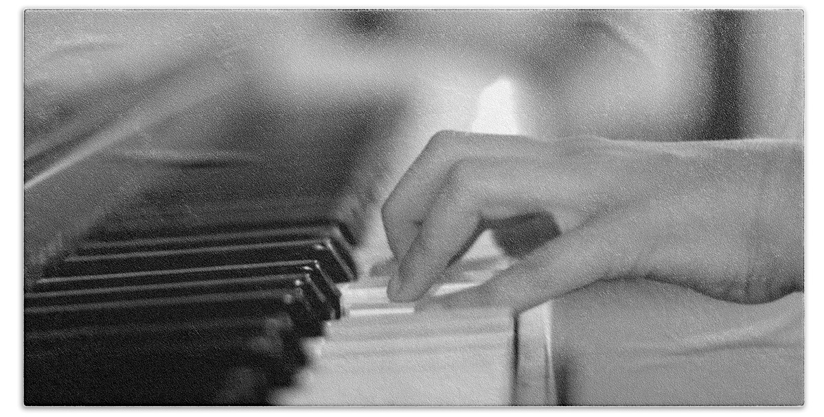 Playing Piano Beach Towel featuring the photograph Hand on piano keyboard by Serena King