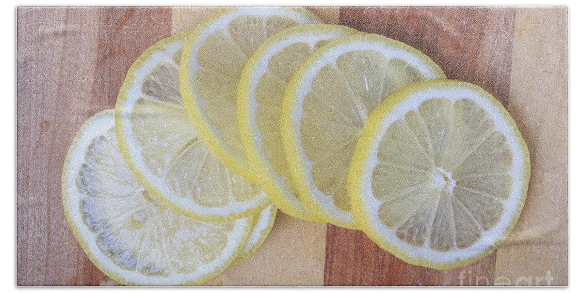 Lemons Beach Towel featuring the photograph Lemon Slices On Cutting Board by Edward Fielding