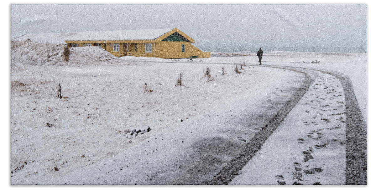 Iceland Beach Towel featuring the photograph Man walking in snow Iceland by Michalakis Ppalis