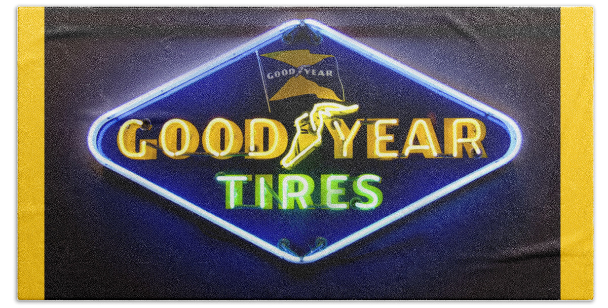 Transportation Beach Towel featuring the photograph Neon Goodyear Tires Sign by Mike McGlothlen