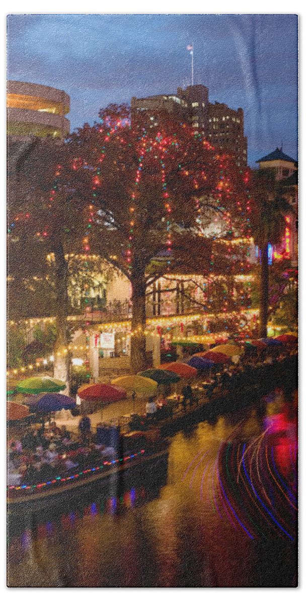 Photography Beach Towel featuring the photograph Restaurant Along A River Lit by Panoramic Images