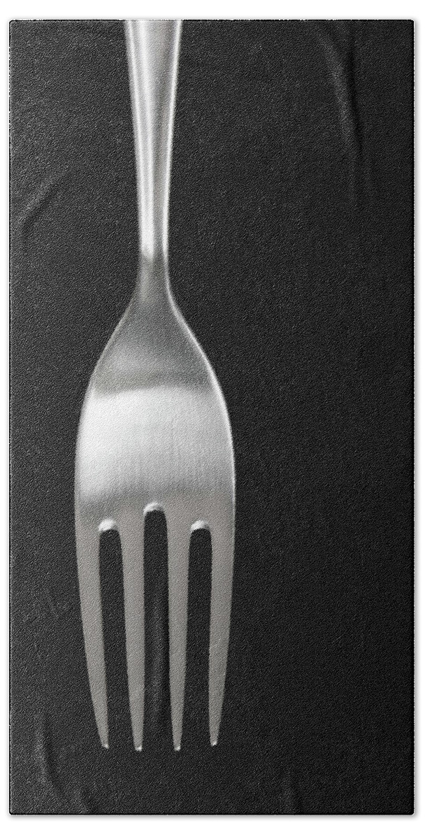 Fork Beach Towel featuring the photograph Shiny silver fork on black background by GoodMood Art