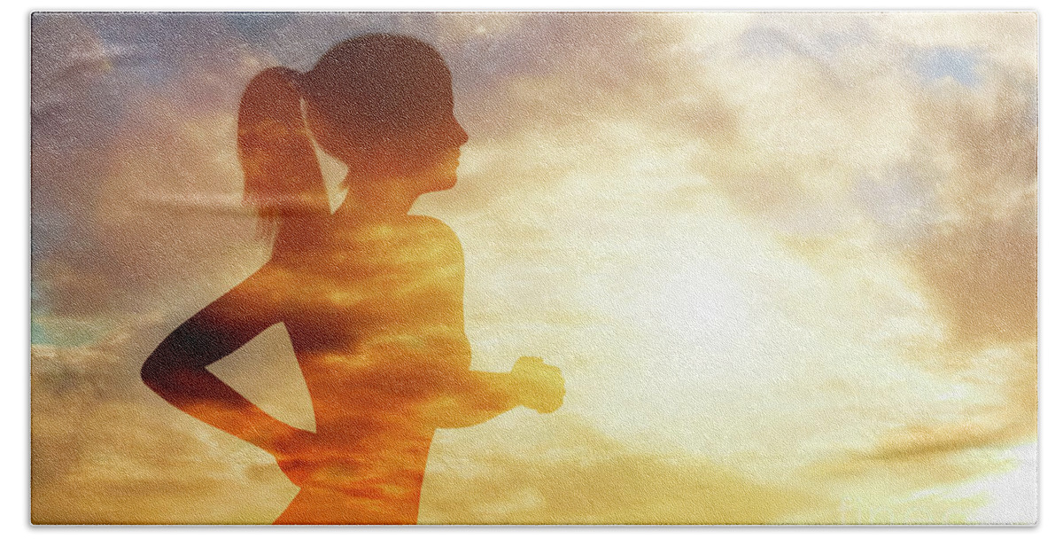 Woman Beach Towel featuring the photograph Silhouette of a running woman on sky background. by Michal Bednarek