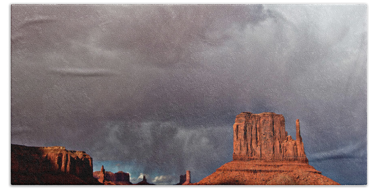 Desert Beach Towel featuring the photograph Storm over Monument Valley by Wesley Aston