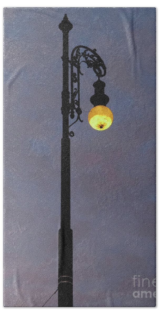 Shining Beach Towel featuring the photograph Street lamp shining at dusk by Michal Boubin