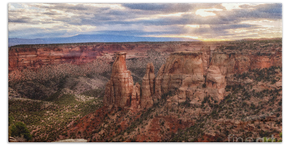 Colorado National Monument Beach Towel featuring the photograph The Sun coming up over the Colorado National Monument by Ronda Kimbrow