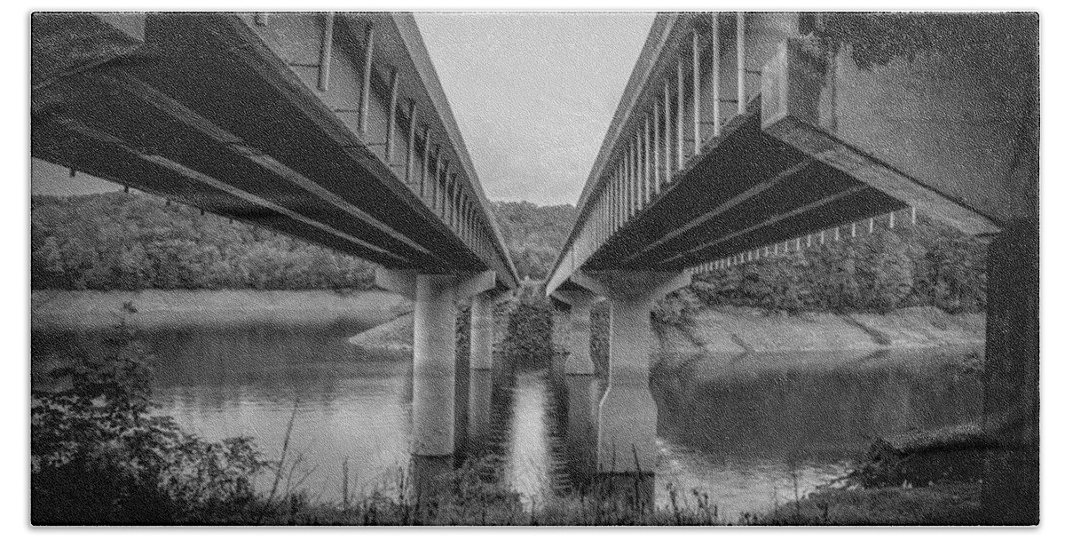 Kelly Hazel Beach Towel featuring the photograph The Underside of Two Bridges Symmetry in Black and White by Kelly Hazel