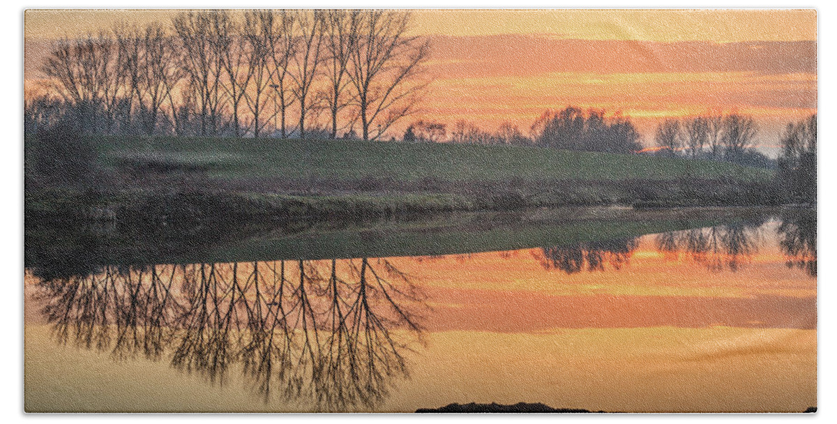 Reflection Beach Towel featuring the photograph Trees reflection in the water at sunset in Meinerswijk by Tim Abeln