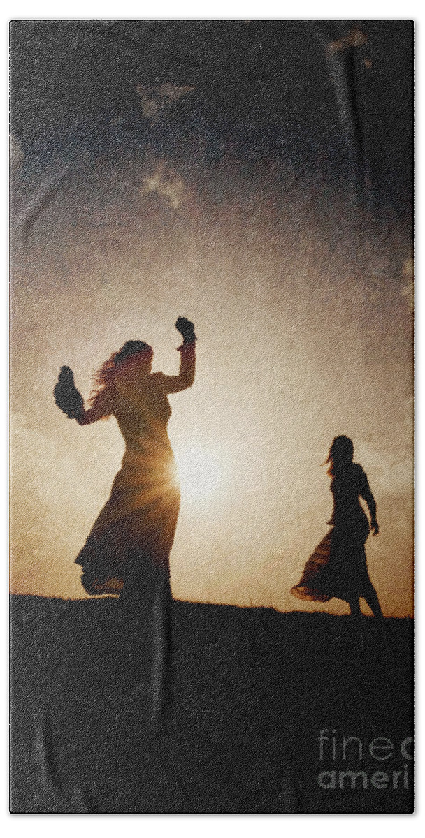 Woman Beach Towel featuring the photograph Two women dancing at sunset by Clayton Bastiani