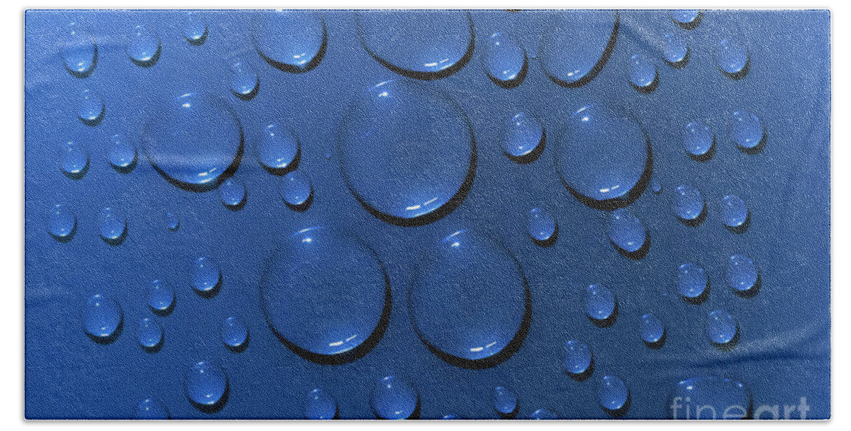 Water Beach Towel featuring the photograph Water drops pattern on blue background by Simon Bratt
