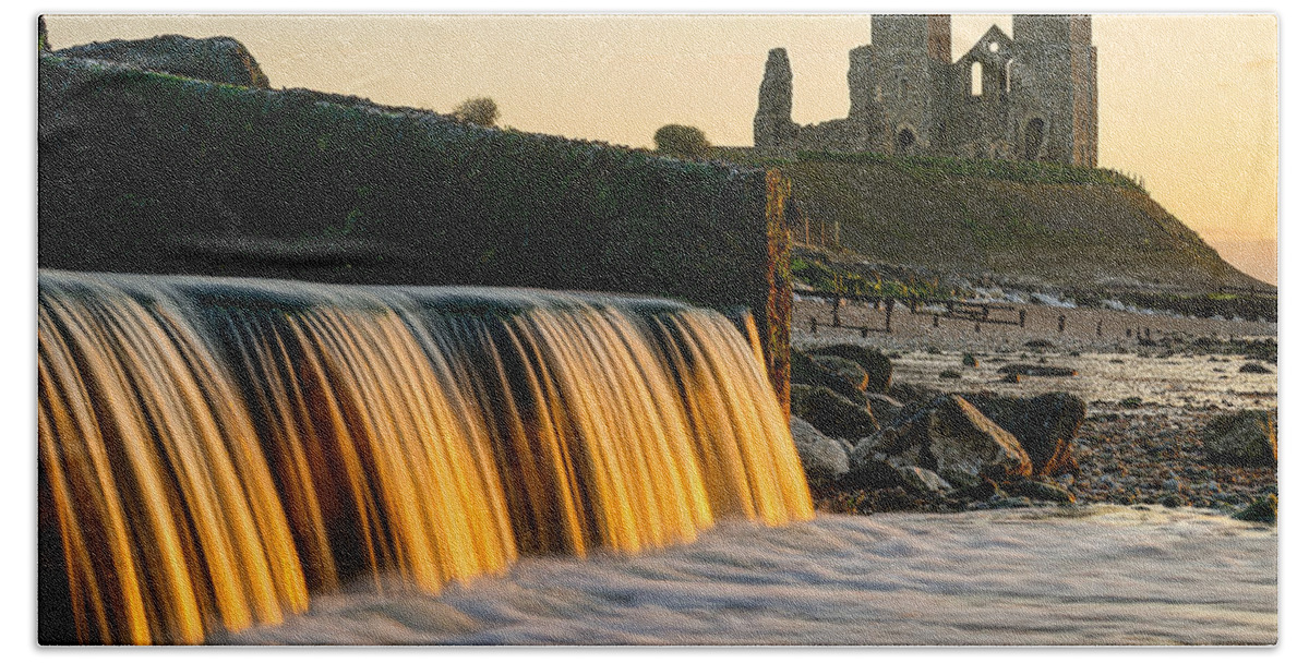 Reculver Towers Beach Towel featuring the photograph A beautiful sunset at Reculver towers in England. by George Afostovremea