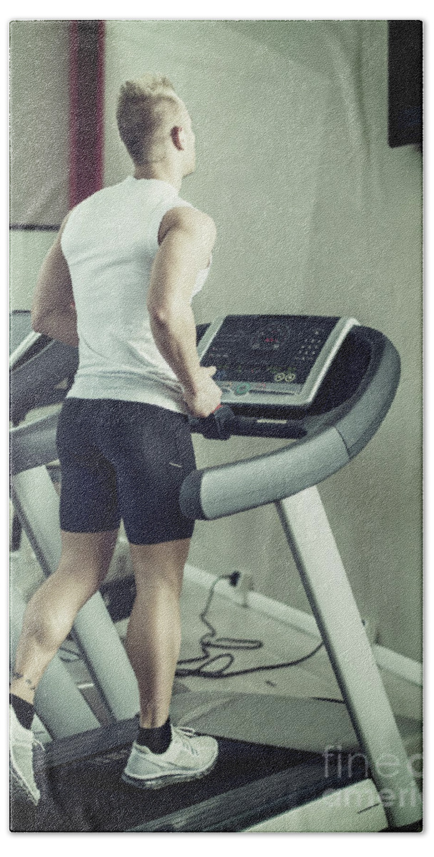 Handsome blond young man exercising pecs on gym equipment Fleece